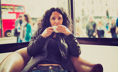 Image showing Pretty brunette drinking coffee tea