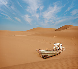 Image showing Old boat among the sand dunes in the desert
