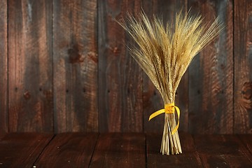 Image showing Wheat Grain Stalks on Grunge Wooden Background