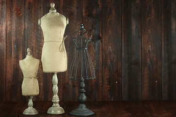 Image showing Antique Mannequin Busts on Wood Grunge Background