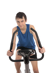 Image showing Teenage boy using an exercise bike fitness