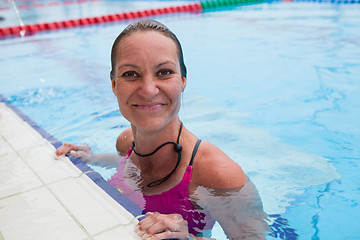 Image showing Female swimmer at pool edge