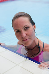 Image showing Female swimmer at pool edge