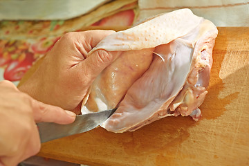 Image showing Bird meat cutting with a knife