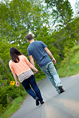 Image showing Man and Woman Walking in Street