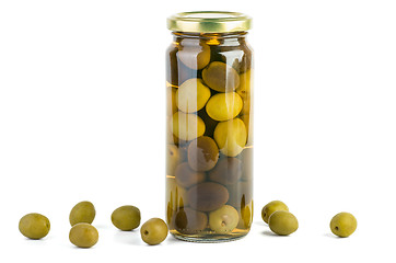 Image showing Glass jar with green and black olives . Some near