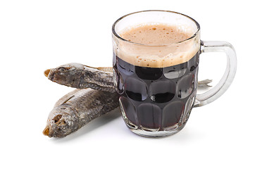 Image showing Glass mug with brown ale and dried fish