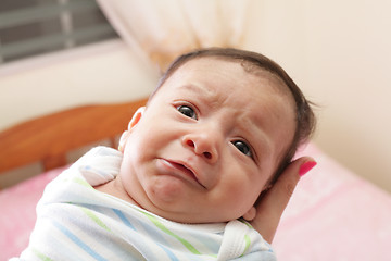 Image showing Woman holding a beautiful sweet hispanic newborn crying 