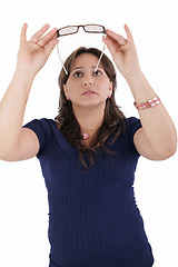 Image showing hispanic young woman checking her eyeglasses