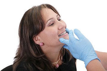 Image showing Female patient looking treating at her dentist