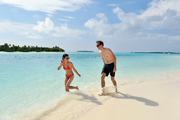 Image showing happy young couple have fun on beach