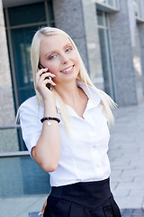 Image showing smiling attractive blonde businesswoman with smartphone 