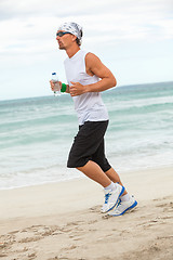 Image showing man is jogging on the beach summertime sport fitness