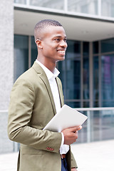 Image showing smiling successful businessman with tablet pc outdoor