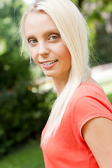 Image showing beautiful young blonde girl lying in grass summertime