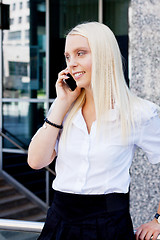 Image showing smiling attractive blonde businesswoman with smartphone 