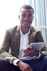 Image showing smiling successful businessman with tablet pc outdoor