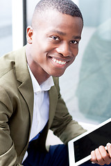 Image showing smiling successful businessman with tablet pc outdoor