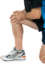 Image showing adult attractive man in sportswear knee pain injury ache isolated