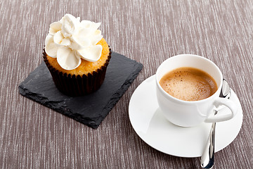 Image showing tasty sweet cupcake and hot aromatic espresso coffee