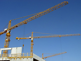 Image showing three cranes against the blue sky