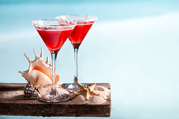 Image showing red drink on beach