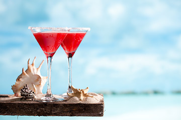 Image showing red drink on beach