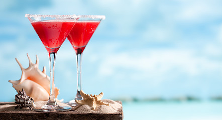 Image showing red drink on beach