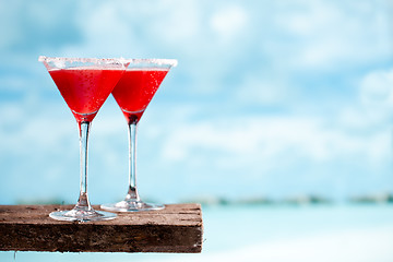 Image showing red drink on beach