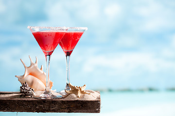 Image showing red drink on beach