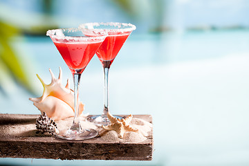 Image showing red drink on beach