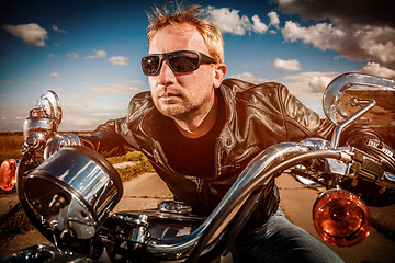 Image showing Biker racing on the road