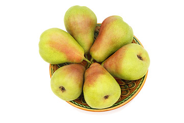 Image showing Ripe pears on the plate on a white background.