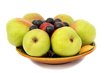 Image showing Pears, plums and prunes on the plate on a white background.