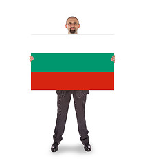 Image showing Smiling businessman holding a big card, flag of Bulgaria