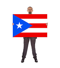 Image showing Smiling businessman holding a big card, flag of Puerto Rico