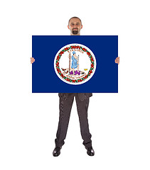 Image showing Smiling businessman holding a big card, flag of Virginia