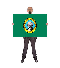 Image showing Smiling businessman holding a big card, flag of Washington