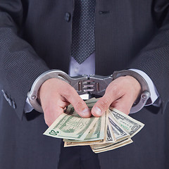 Image showing Business man in handcuffs arrested for bribe