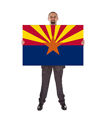 Image showing Smiling businessman holding a big card, flag of Arizona