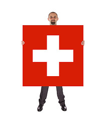 Image showing Smiling businessman holding a big card, flag of Switzerland