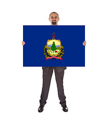 Image showing Smiling businessman holding a big card, flag of Vermont