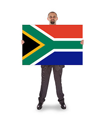 Image showing Smiling businessman holding a big card, flag of South Africa