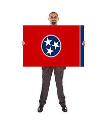 Image showing Smiling businessman holding a big card, flag of Tennessee