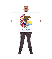Image showing Smiling businessman holding a big card, flag of Illinois