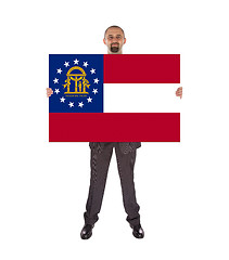 Image showing Smiling businessman holding a big card, flag of Georgia