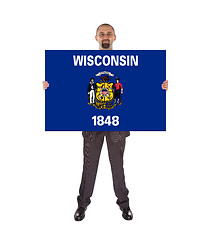 Image showing Smiling businessman holding a big card, flag of Wisconsin