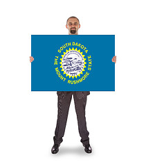 Image showing Smiling businessman holding a big card, flag of South Dakota