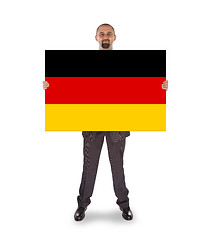 Image showing Smiling businessman holding a big card, flag of Germany