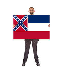 Image showing Smiling businessman holding a big card, flag of Mississippi